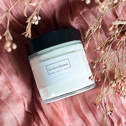 Immerse yourself in the serene beauty of our 4oz Unscented Whipped Tallow Balm, showcased on a luxurious dusty rose gold pink cheesecloth runner. Bathed in soft sunlight from the right, the jar exudes simplicity and elegance. Above the jar, a delicate bundle of dried florals with pink bud tips adds a touch of nature's grace. Experience the purity of our unscented skincare, complemented by a visual symphony of soft hues and natural elements. Elevate your self-care routine with the essence of tranquility